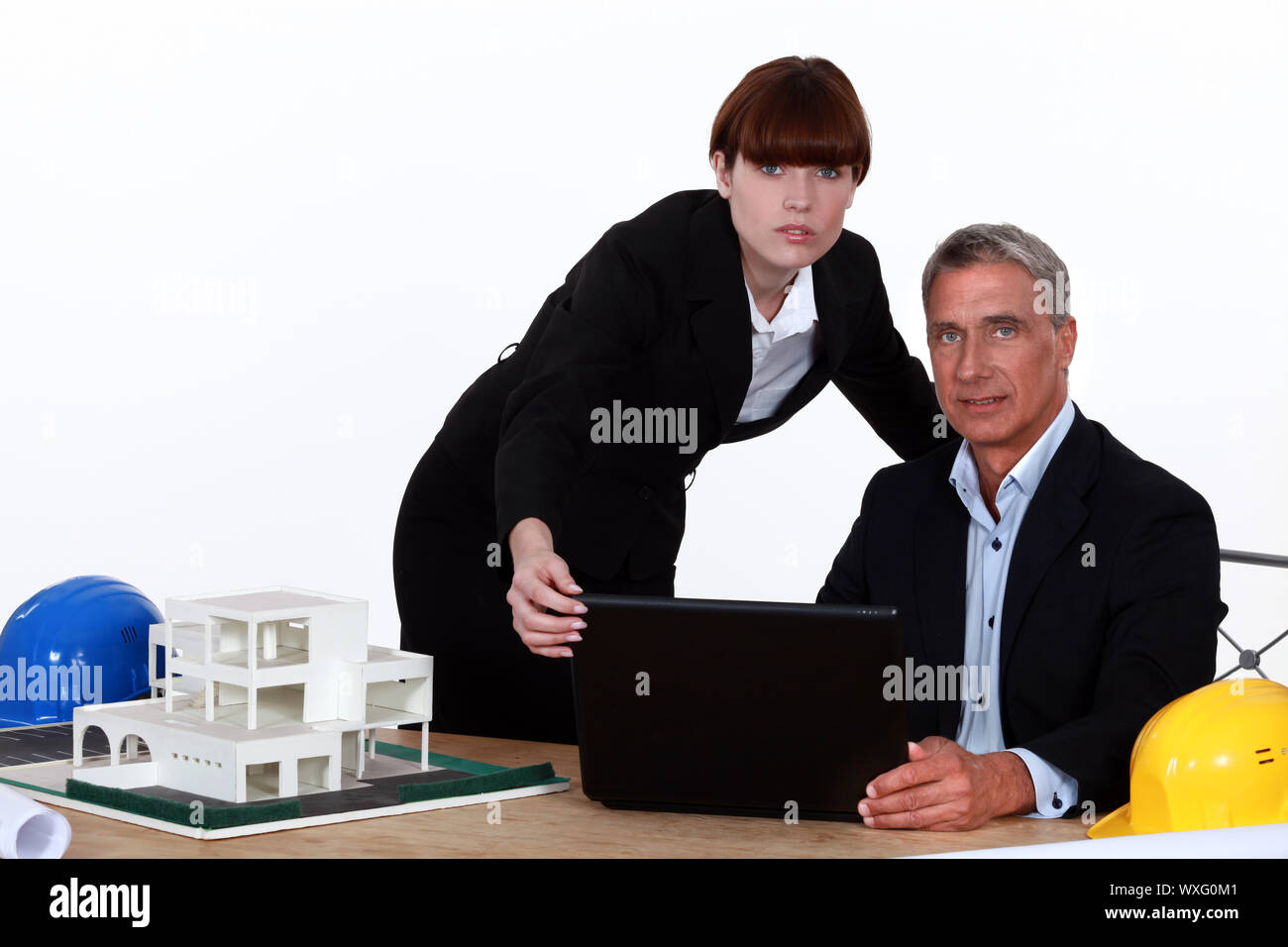 Architect and assistant working on housing project Stock Photo - Alamy