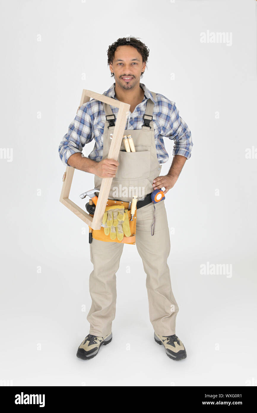 A carpenter holding a frame Stock Photo