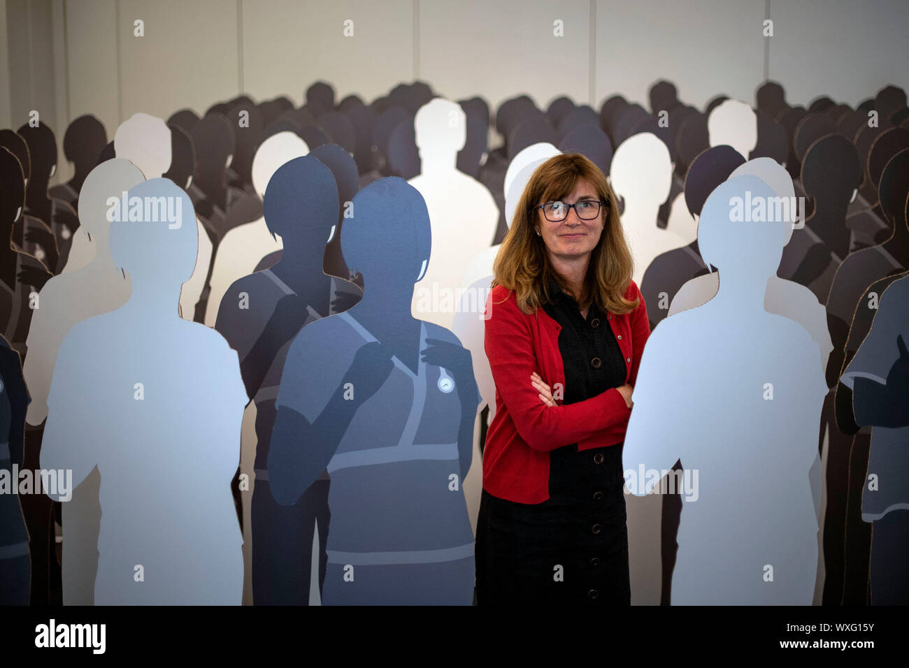 Nurse Patricia Marquis with 100 lifesize cardboard cutouts of nurses