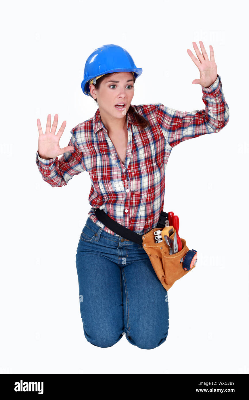 Tradeswoman stuck behind an invisible wall Stock Photo - Alamy