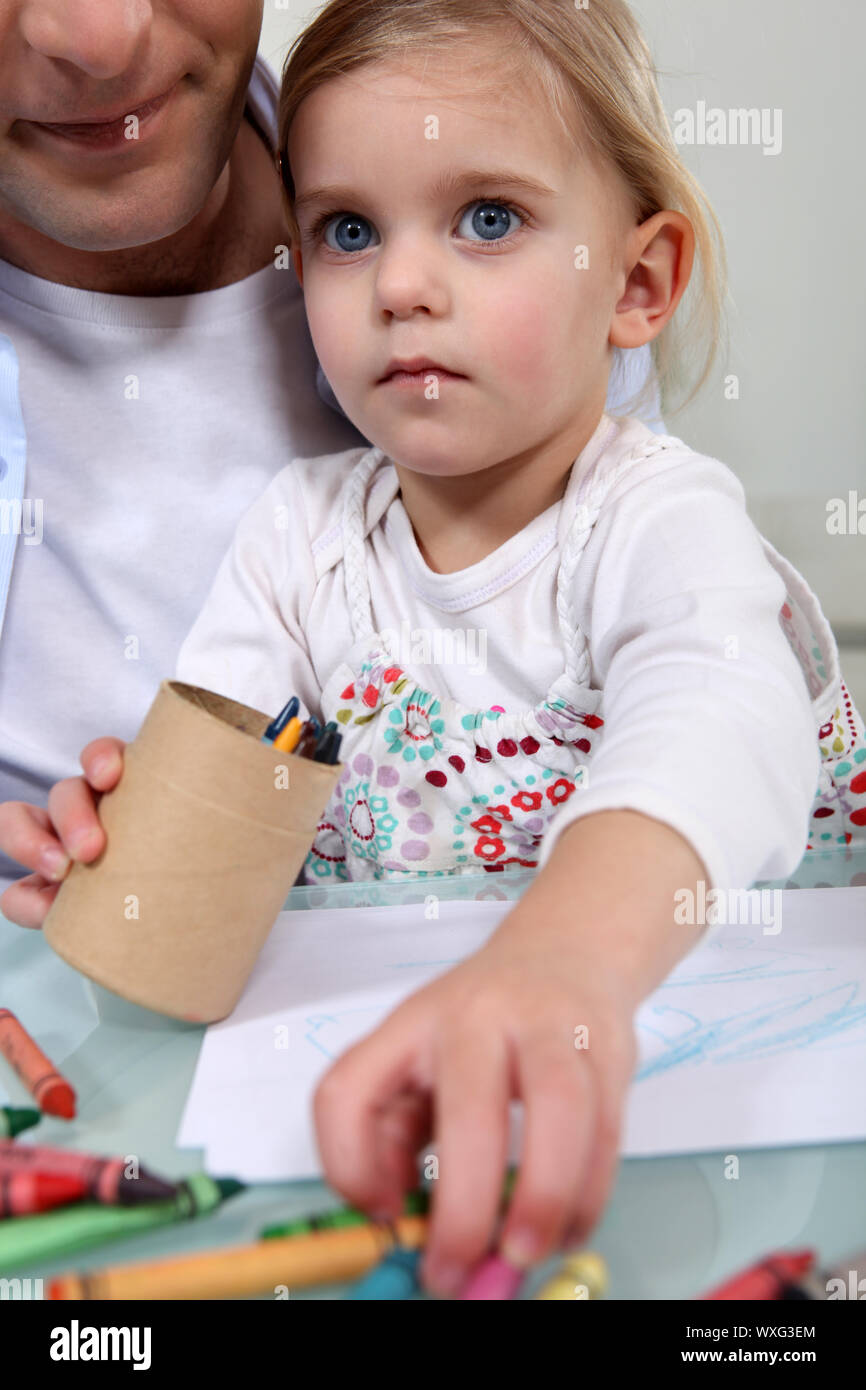 Little girl drawing with crayons Stock Photo - Alamy