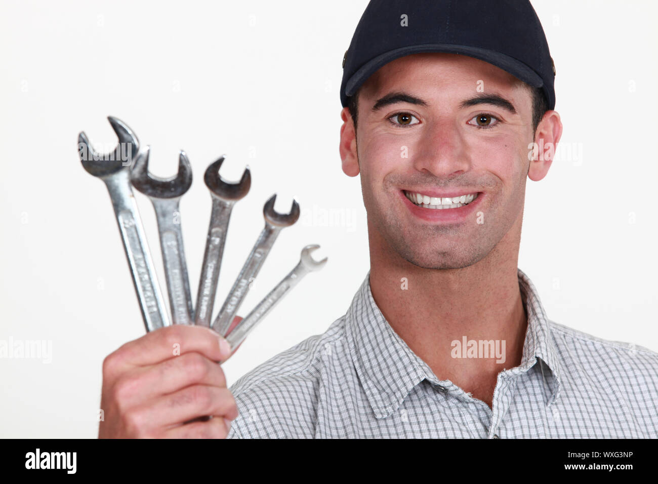 Man holding wrenches Stock Photo Alamy