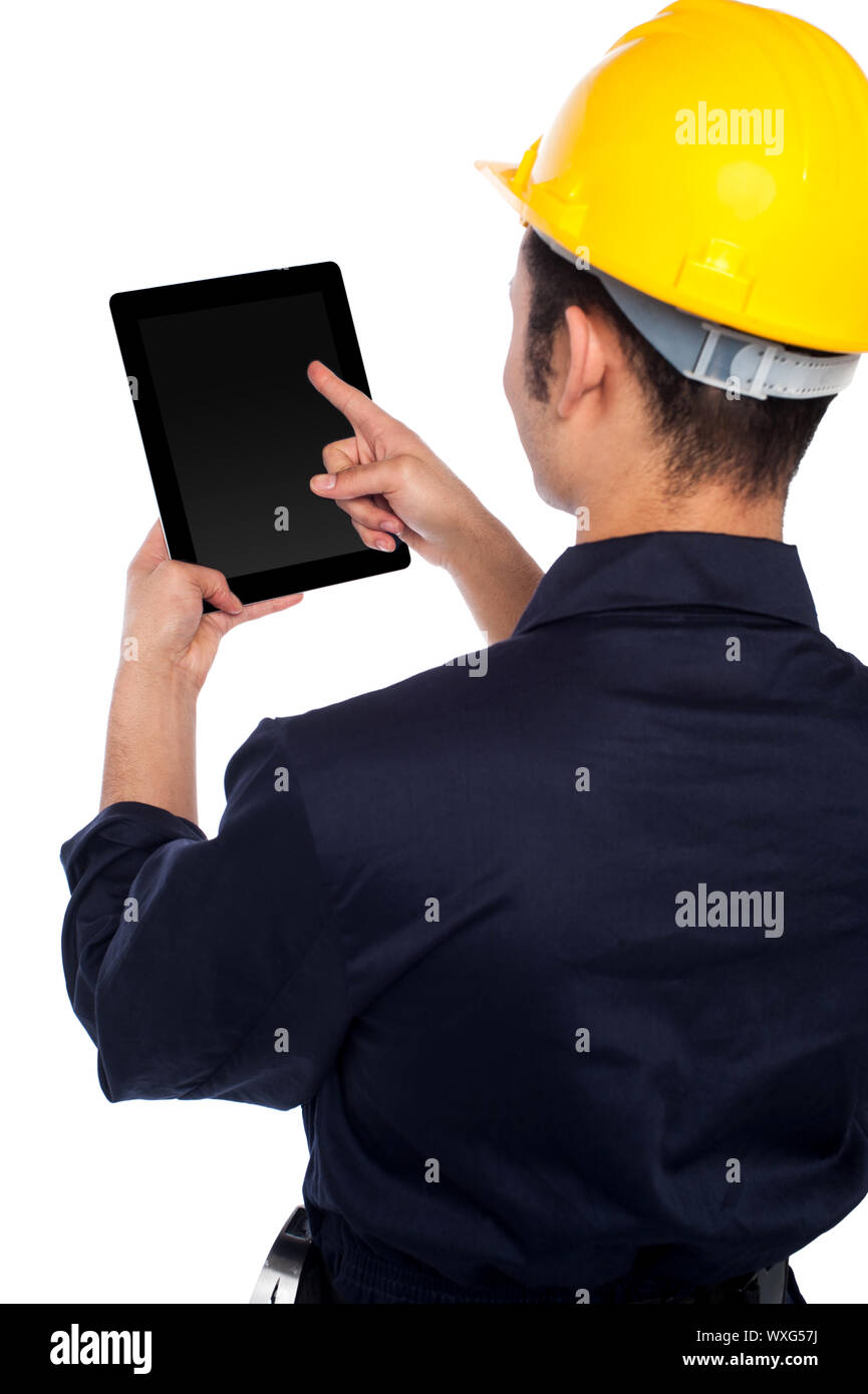 Young construction worker operating touch pad device Stock Photo