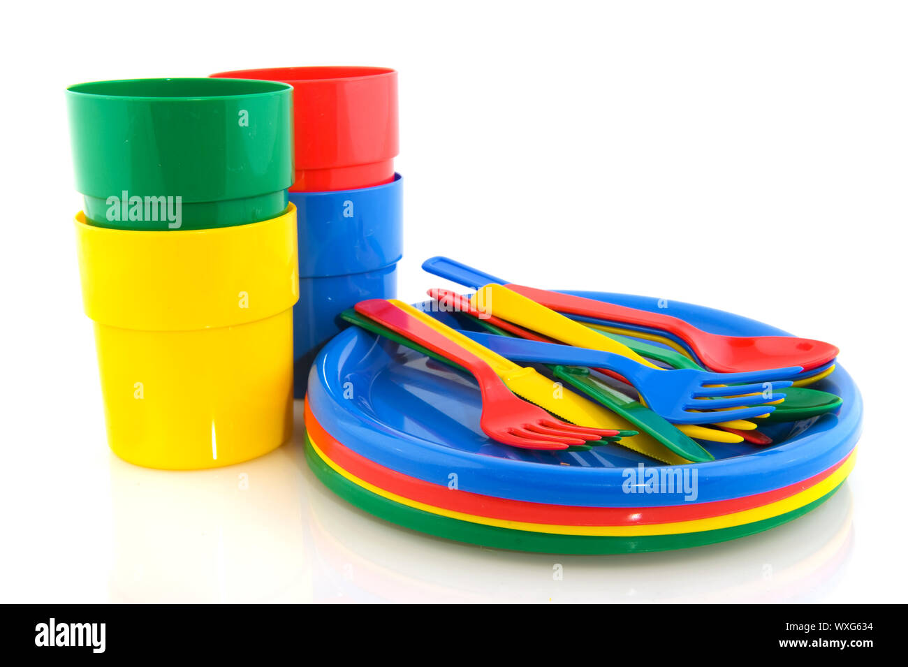 Plastic plates mugs and forks spoons and knifes in colorful plastic