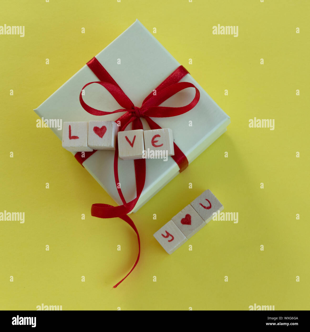 Isolated gift box with "Love you" on text yellow background and copy ...