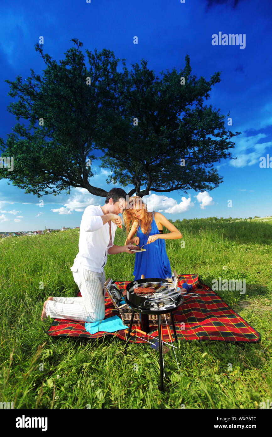 man and woman on picnic in green grass Stock Photo - Alamy