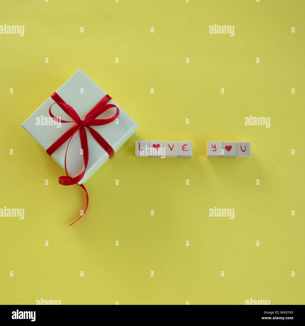Isolated gift box with "Love you" on text yellow background and copy ...