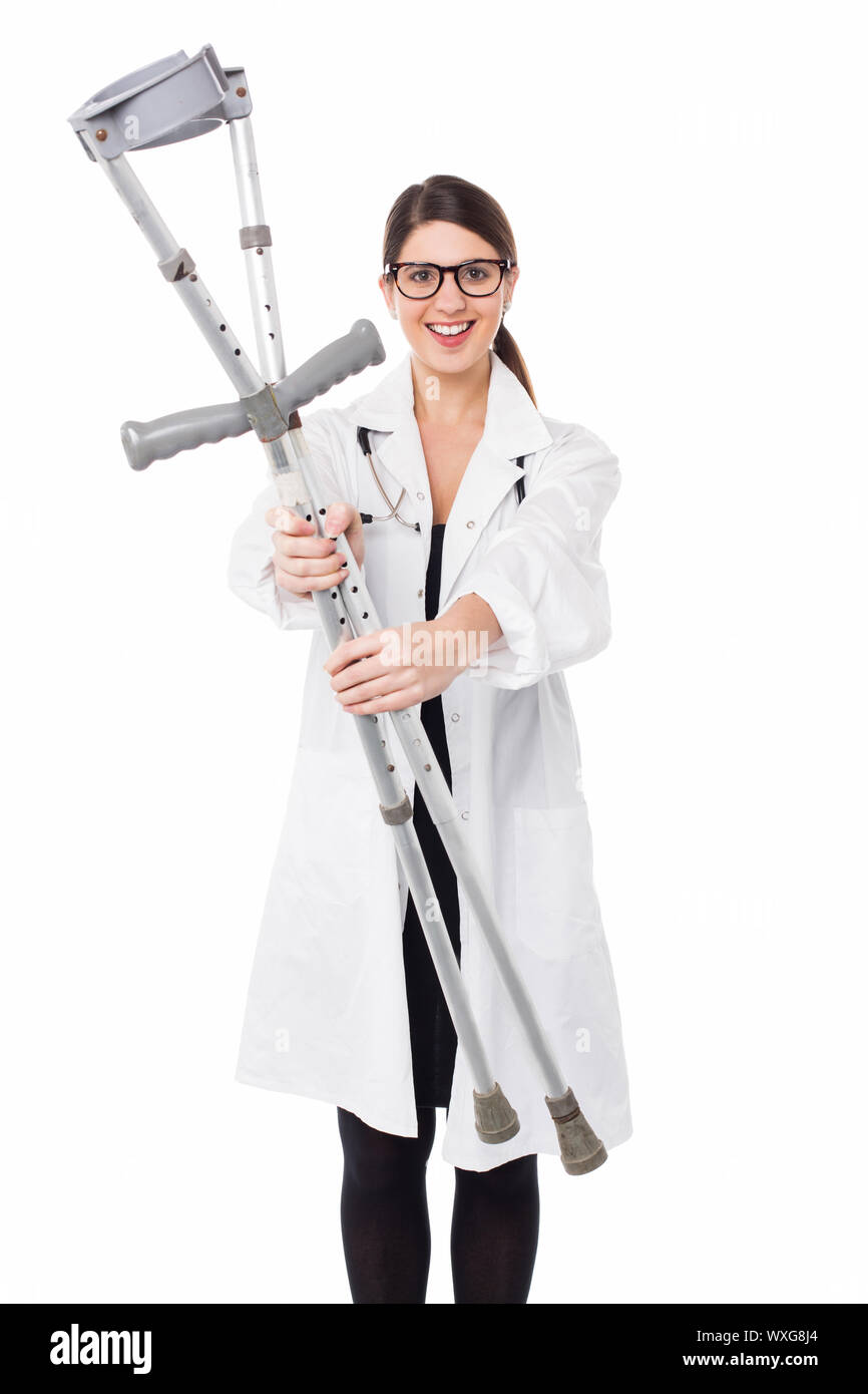 Medical practitioner handing over pair of crutches to patient Stock Photo