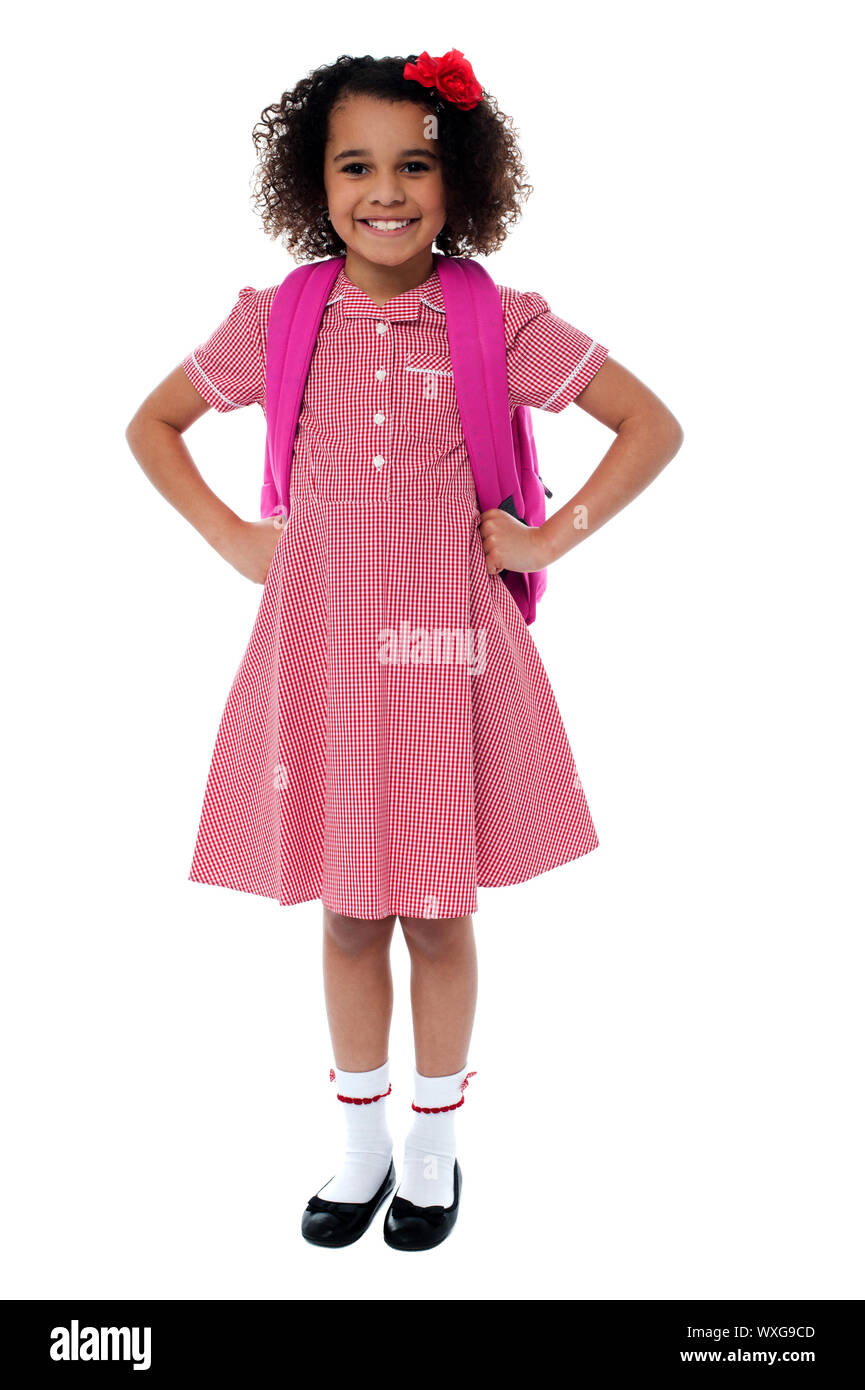 Confident cute school girl in uniform carrying pink backpack with hands on  her waist Stock Photo - Alamy