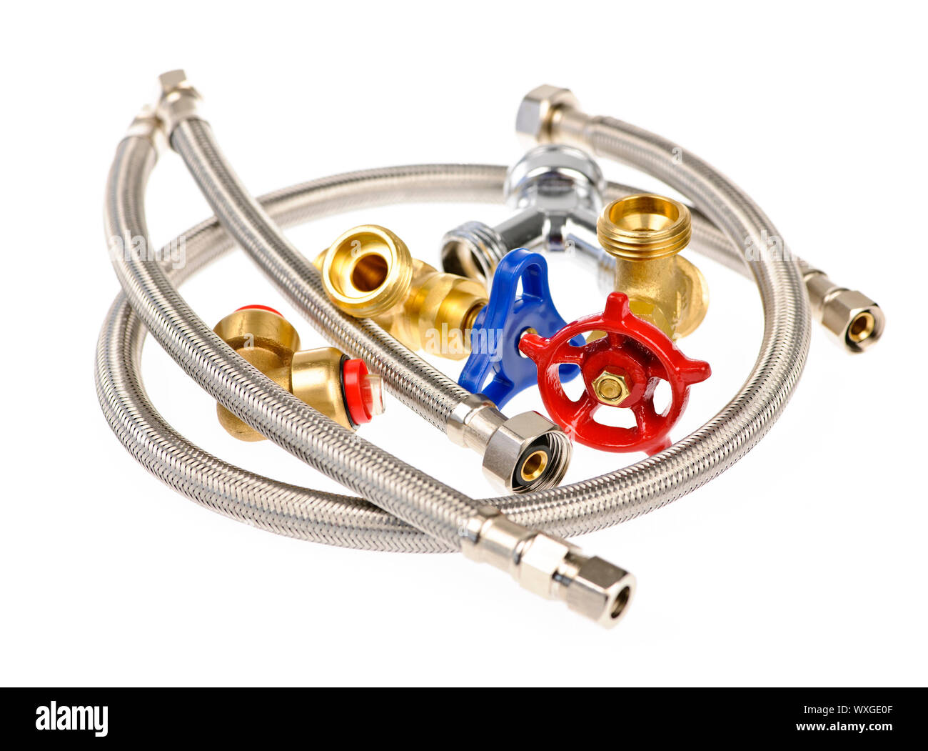Pile of plumbing valves hoses and assorted parts isolated on white