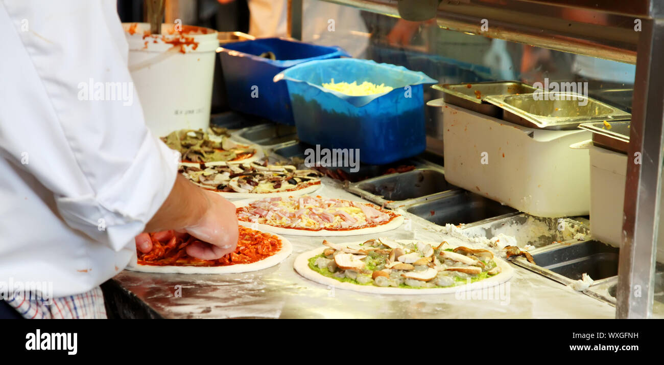 Different Pizza Being Made in a Kitchen Stock Photo