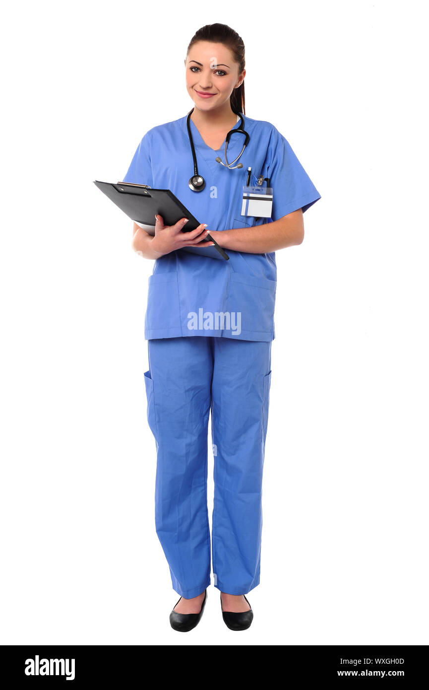 Pretty young medical practitioner posing with clipboard in hands Stock Photo