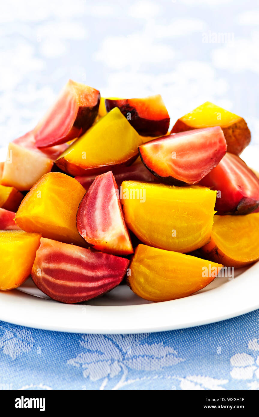 Closeup of roasted sliced red and golden beets on a plate Stock Photo