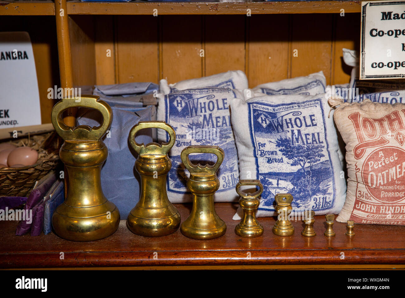 UK, County Durham, Beamish, Museum, Town, Annfield Plain Industrial Co-Op shop, provisions department, shelf of flour bags with graduated brass weight Stock Photo