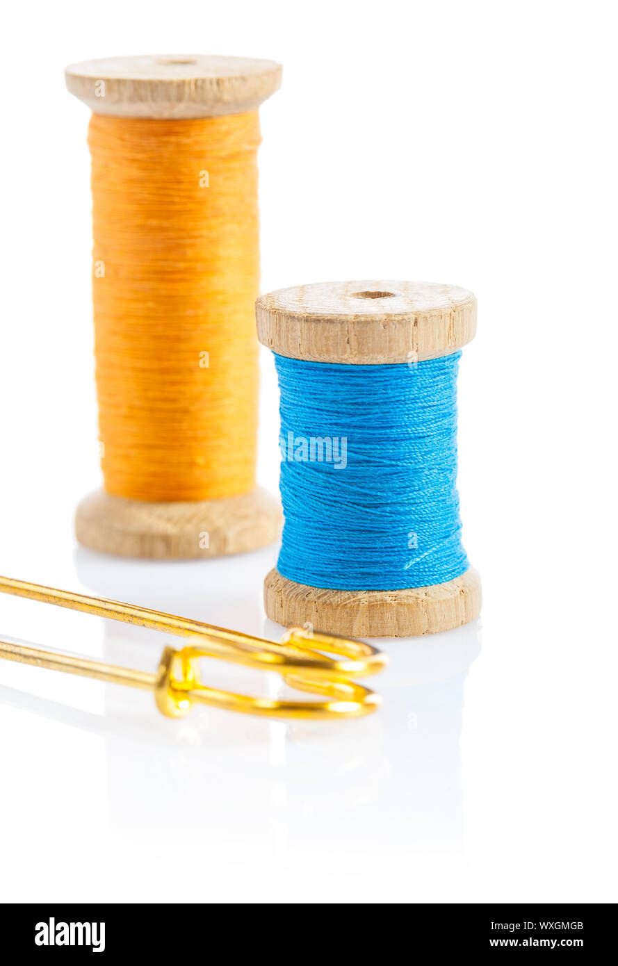 sewing bobbins and safety pin Stock Photo Alamy