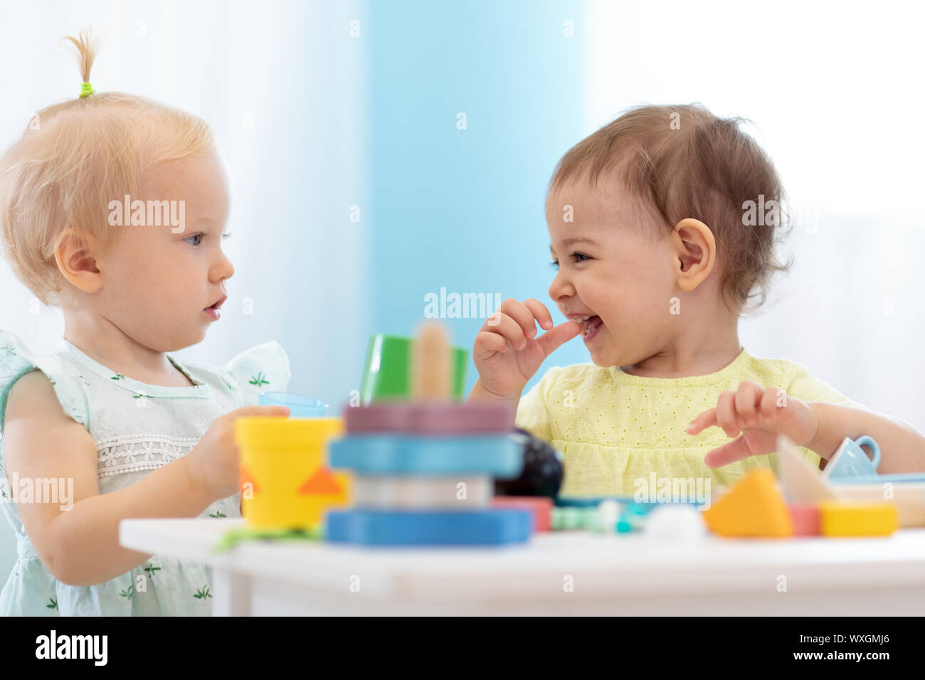 Kids playing educational toys in playroom at nursery Stock Photo - Alamy