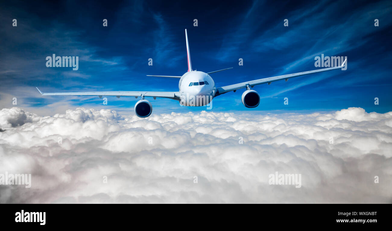 Passenger Airliner flying in the clouds Stock Photo - Alamy