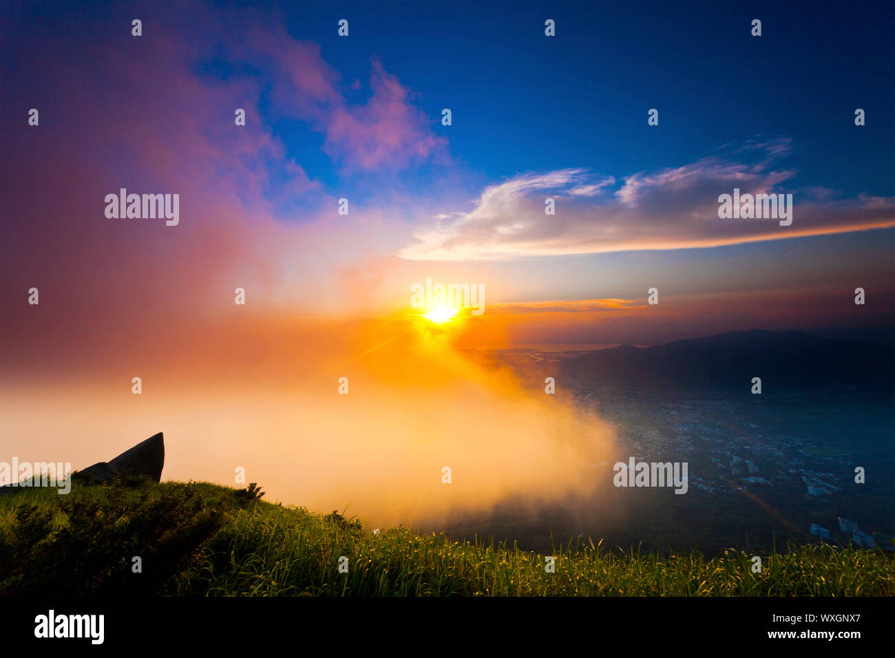 Hong Kong mountain sunset with clouds moving Stock Photo - Alamy