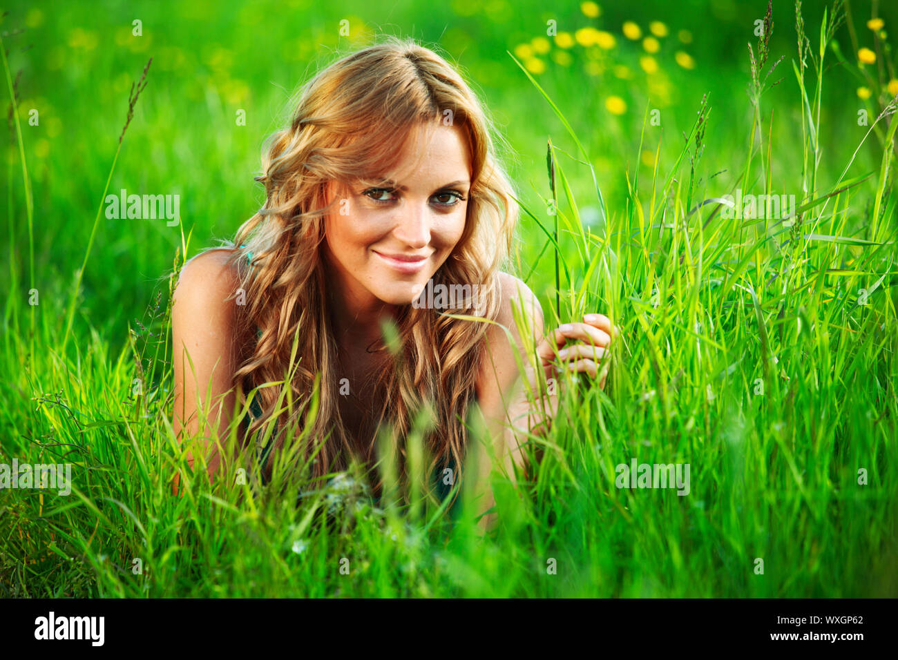woman on the green grass happy and smile Stock Photo - Alamy