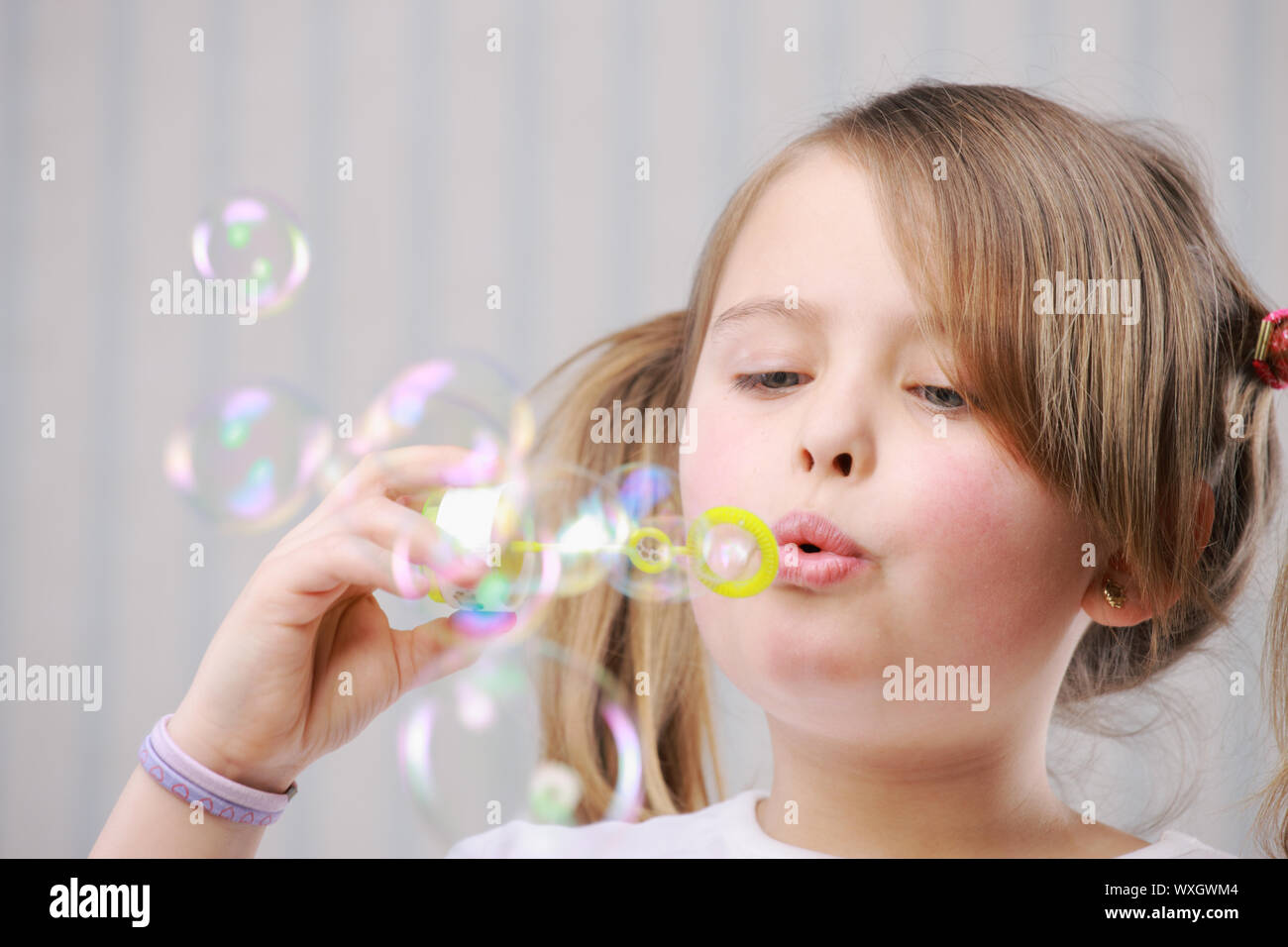 Portrait of a little girll blowing bubbles Stock Photo