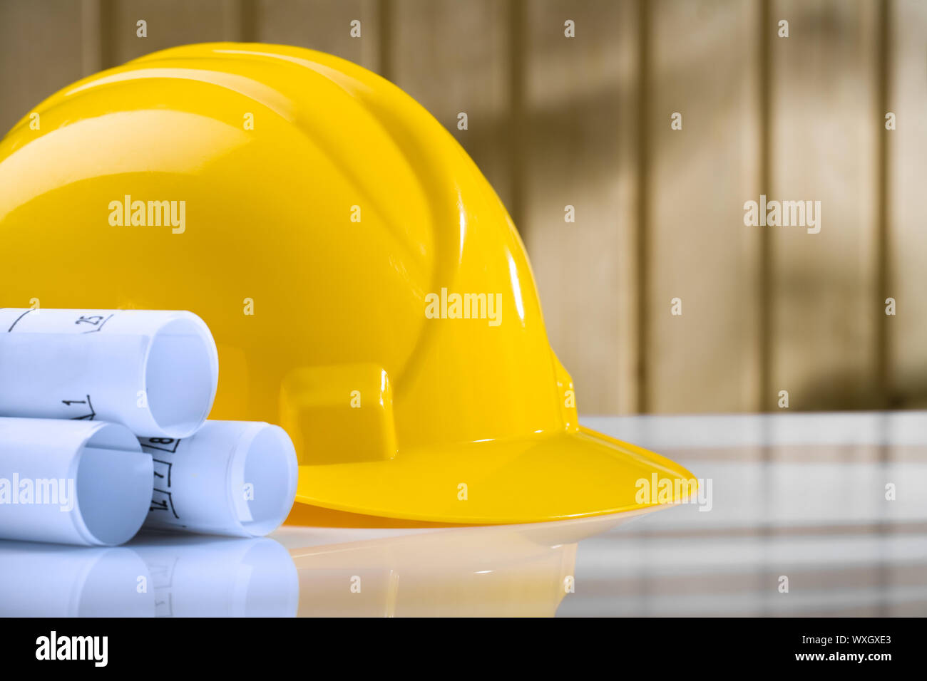 blueprints and yellow helmet on white table Stock Photo