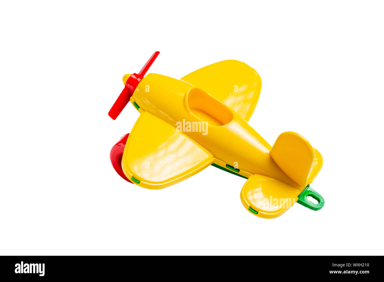yellow toy airplane with propeller and landing gear isolate on a white background without shadow. concept of travel and flight. Stock Photo