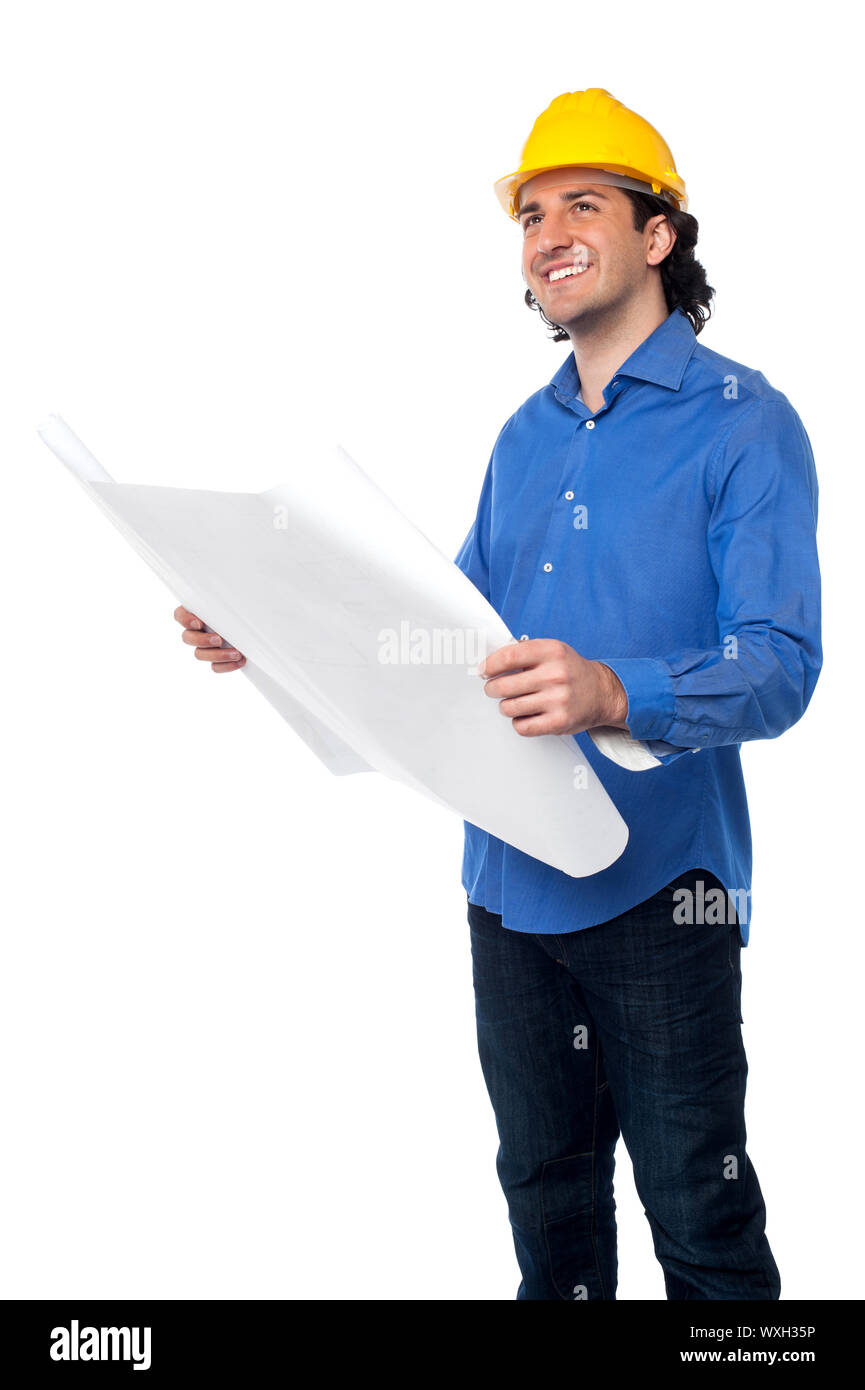 Architect with hard hat holding out construction plan Stock Photo