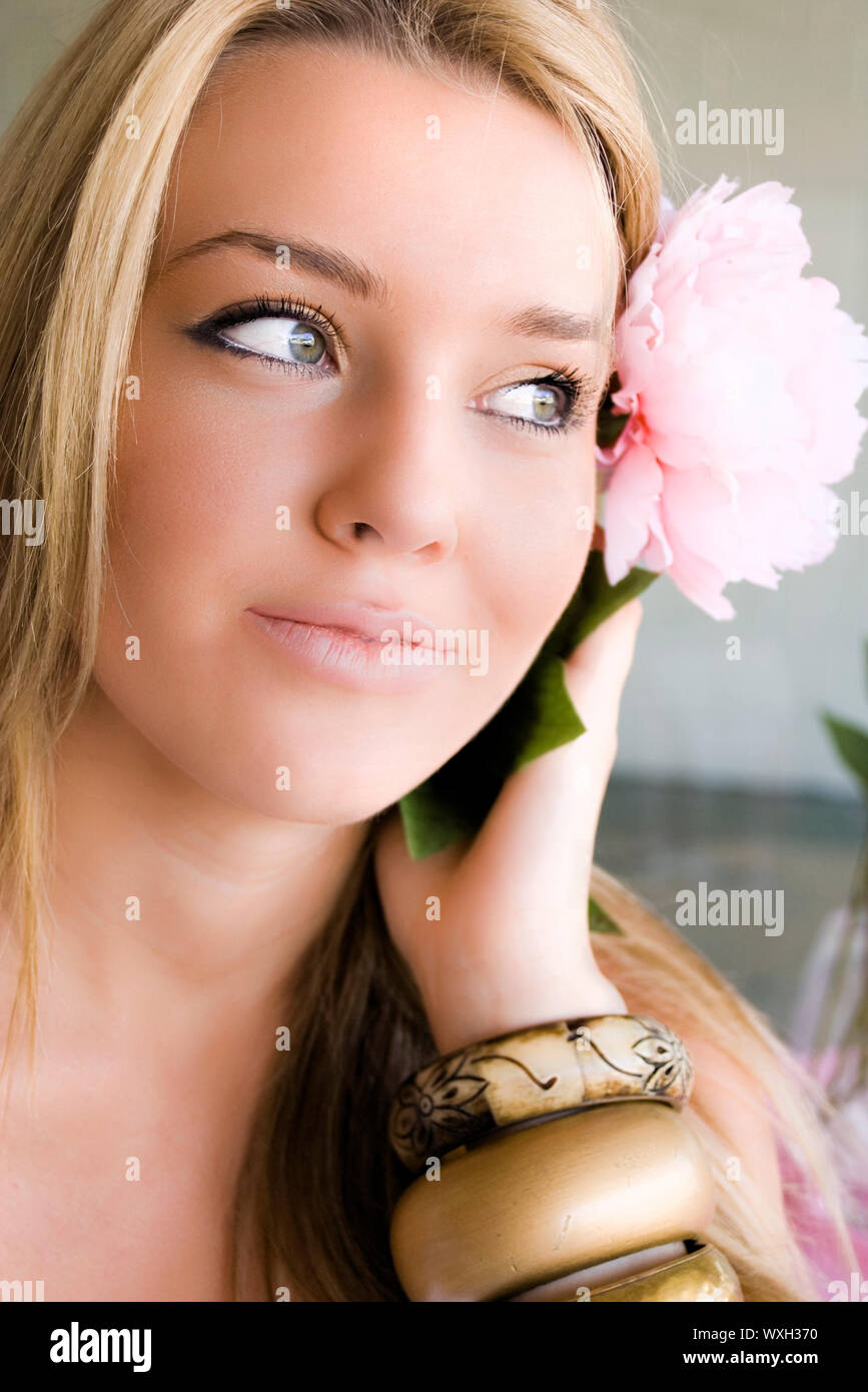 Beautiful girl with a flower in her hair Stock Photo - Alamy