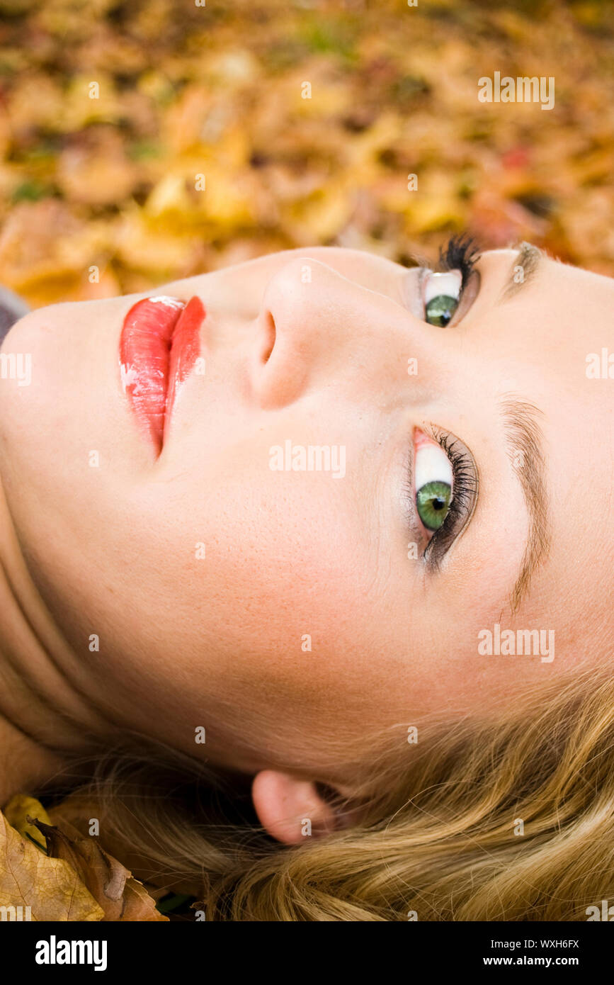 Young girl lying in the Autumn fall leaves Stock Photo - Alamy