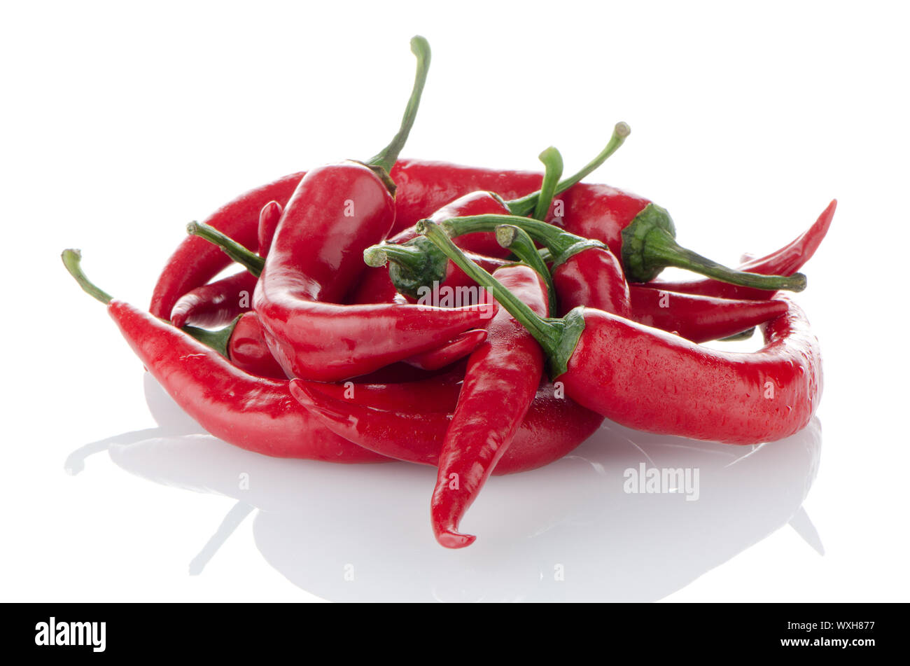 Some red hot peppers on a white background Stock Photo - Alamy