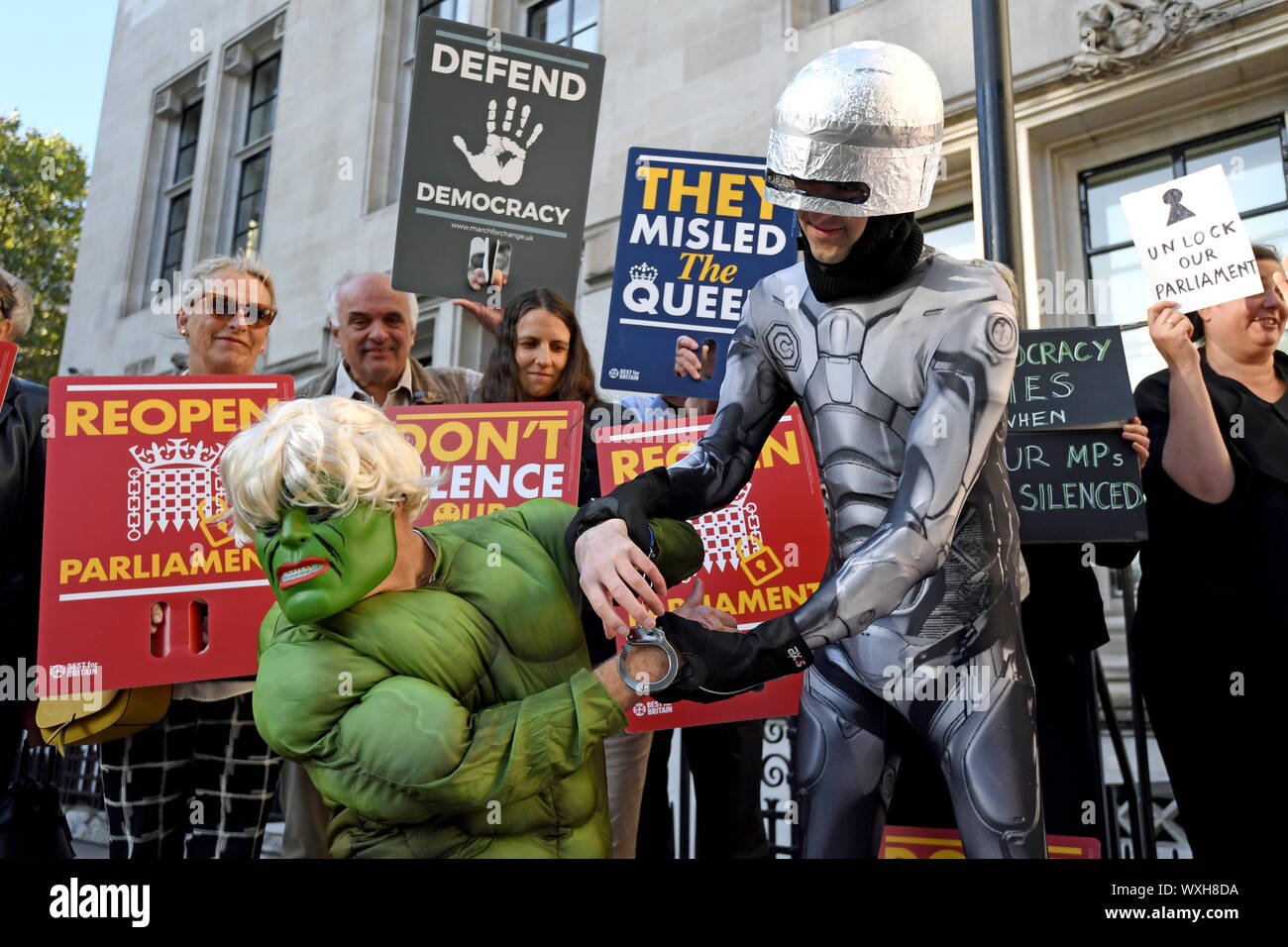 Protesters dressed as the Incredible Hulk and Robocop outside the Supreme Court in London where judges are due to consider legal challenges to Prime Minister Boris Johnson's decision to suspend Parliament. Stock Photo