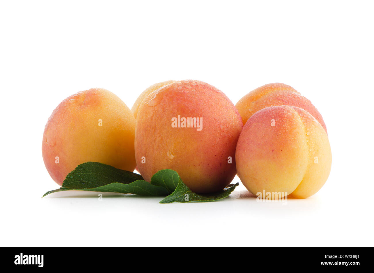 Sweet peaches with leafs on a white background Stock Photo