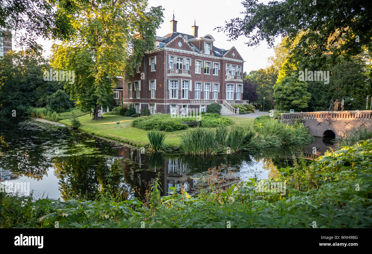 Rotterdam, Netherlands. June 29, 2019. Villa Jamin surrounded by nature. A peaceful river flowing under a bridge. Destination for vacation. Stock Photo