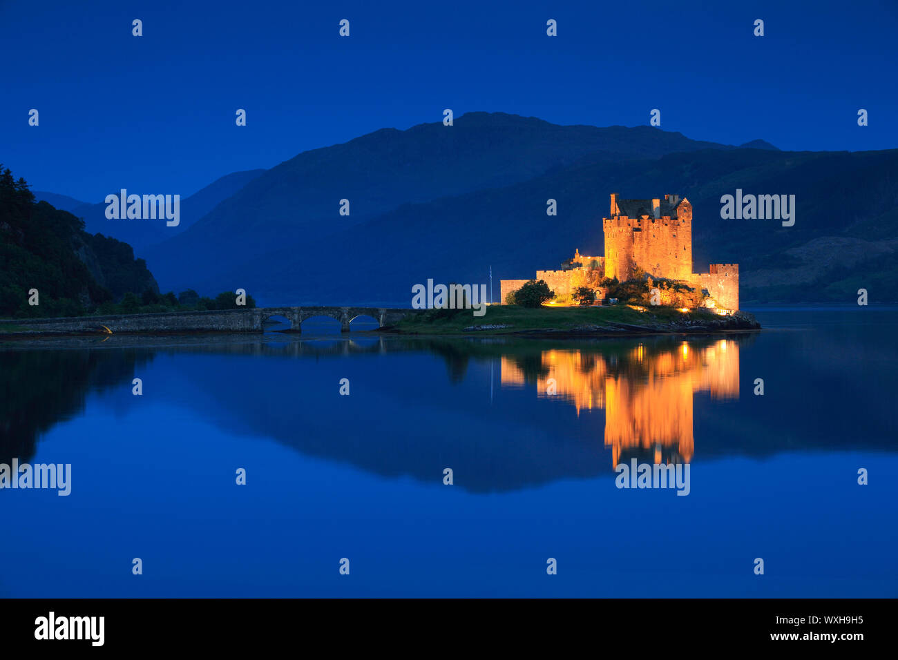 Eilean Donan Castle in the evening. The castle is built in a small island where three lochs converge - Loch Alsh, Loch Long, and Loch Duich. Highlands, Scotland Stock Photo