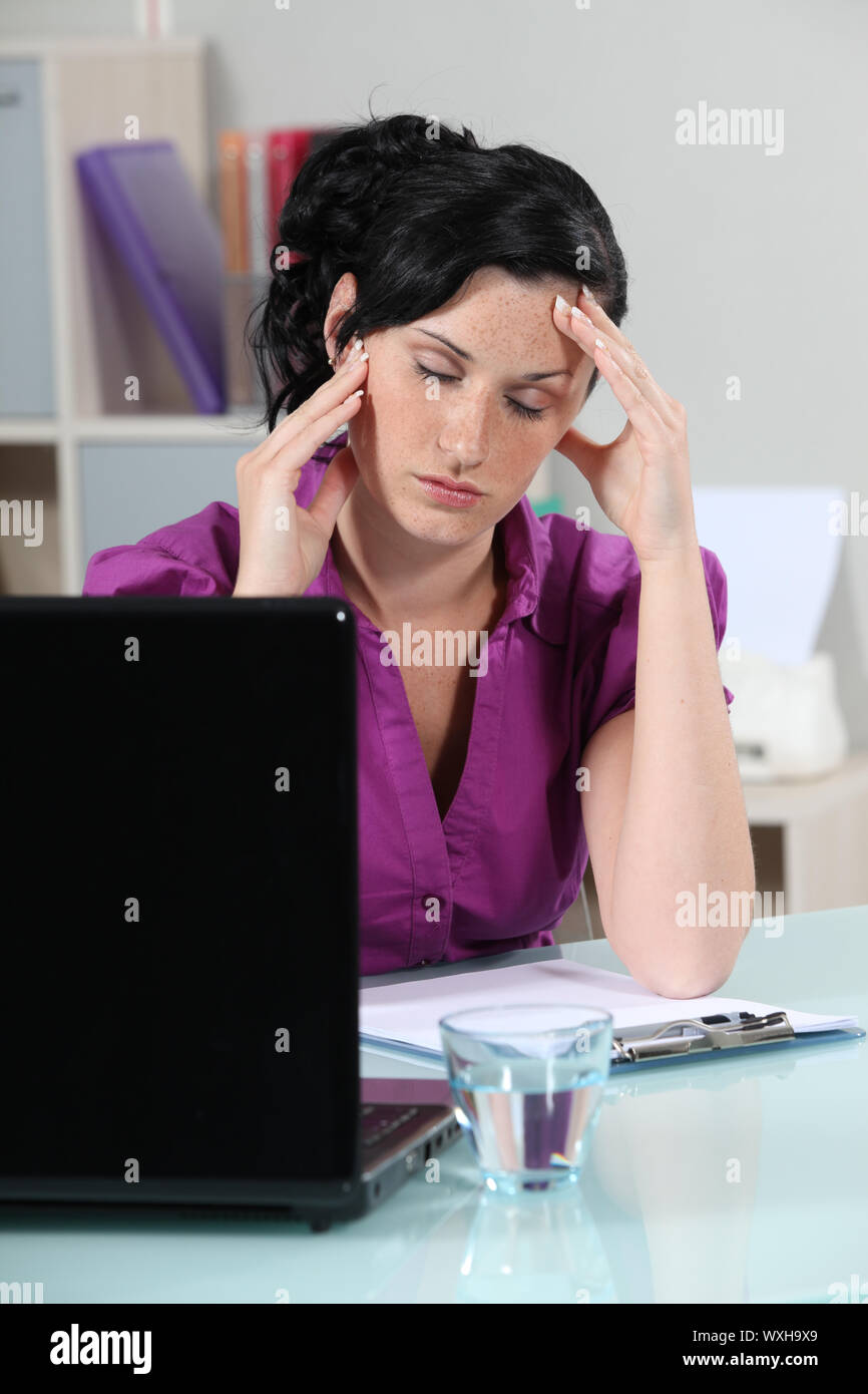 Businesswoman suffering from migraine Stock Photo