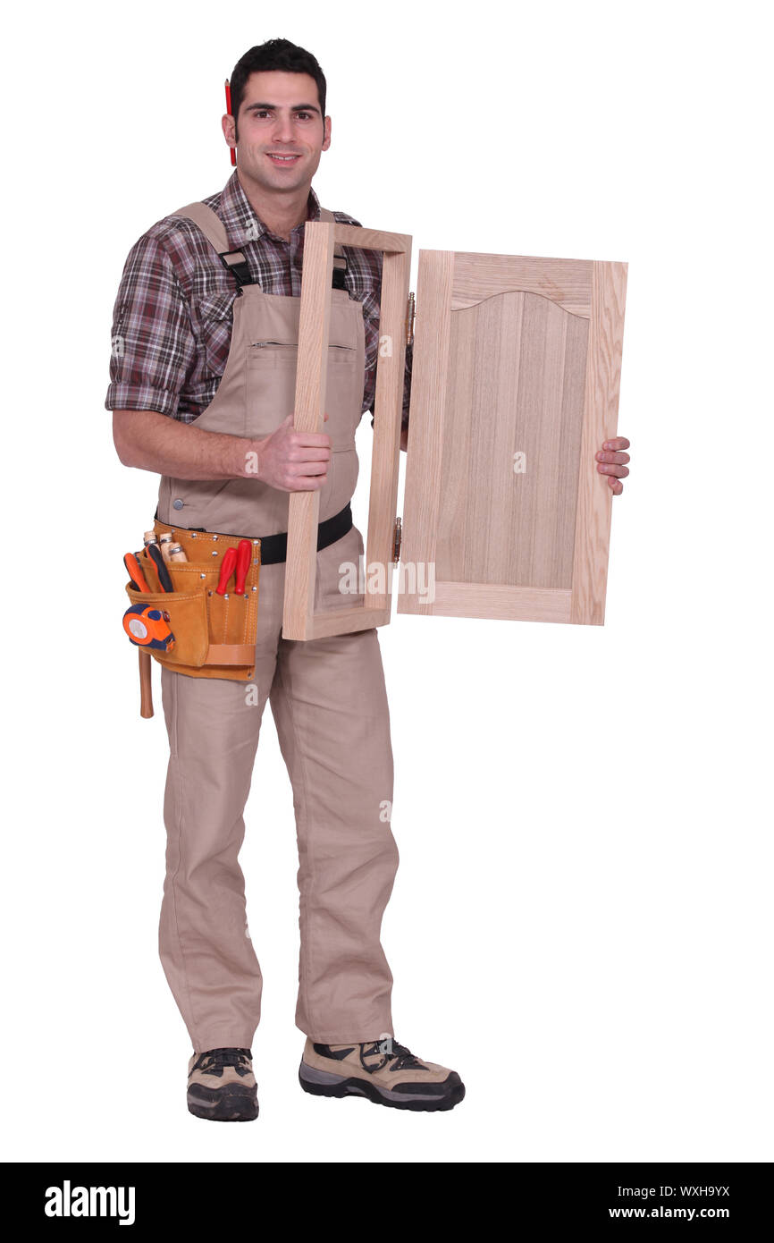 carpenter holding a wooden window frame Stock Photo Alamy