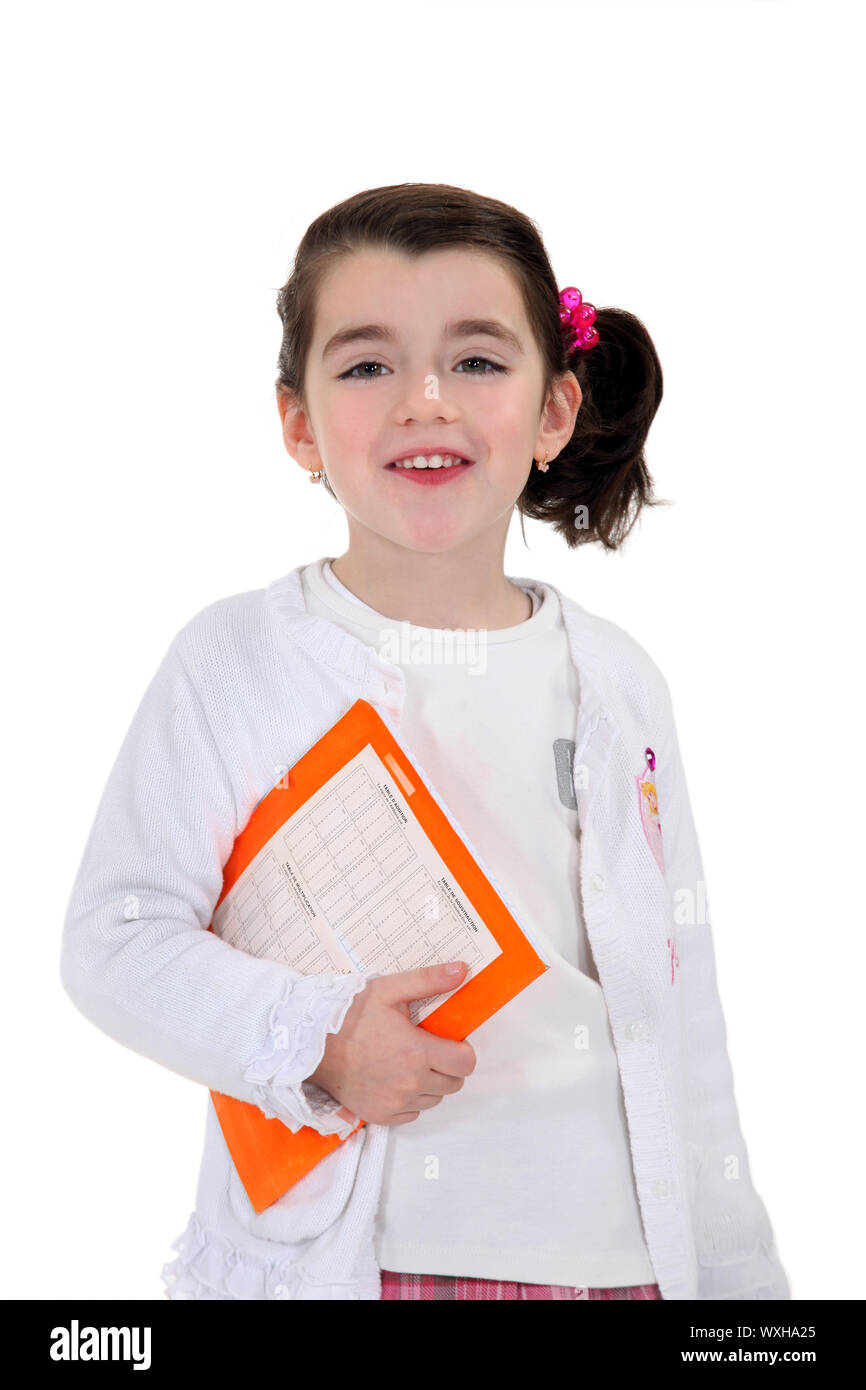 Little girl carrying text book Stock Photo