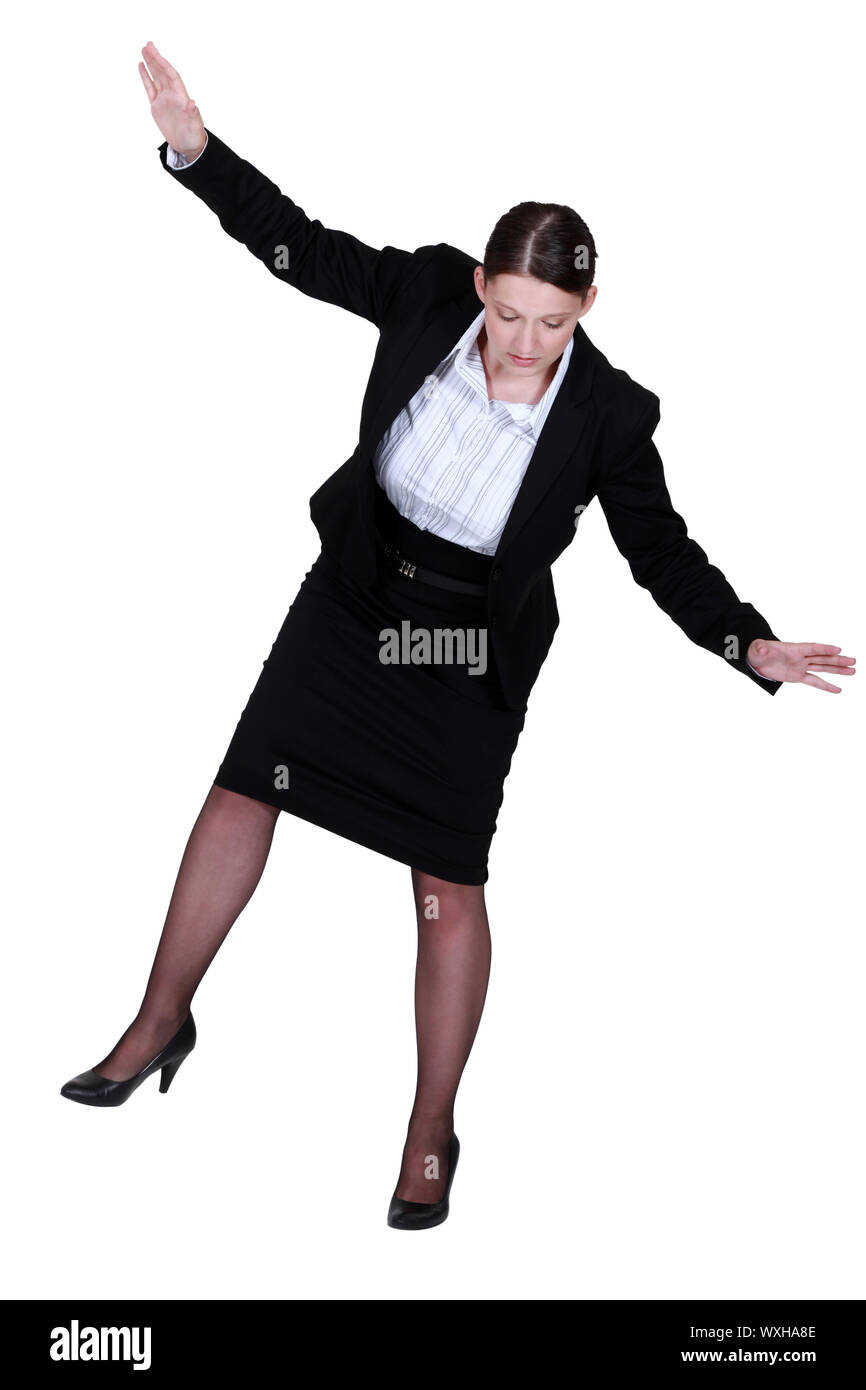 female businesswoman miming tightrope walker Stock Photo
