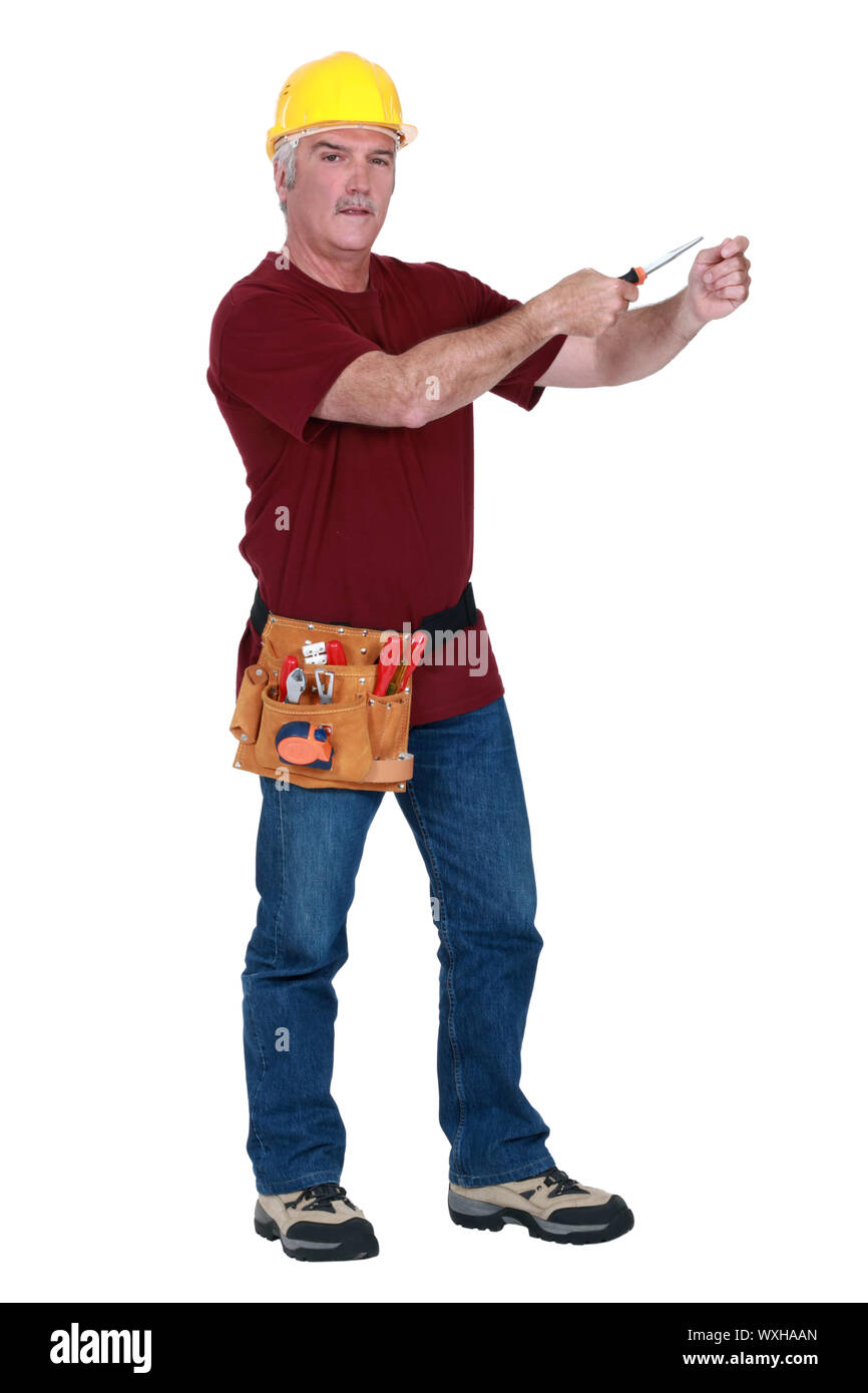 Grey-haired man holding screw-driver Stock Photo