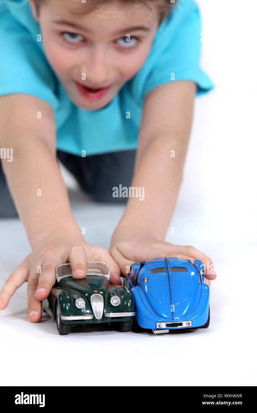 Boy playing with toy cars Stock Photo - Alamy