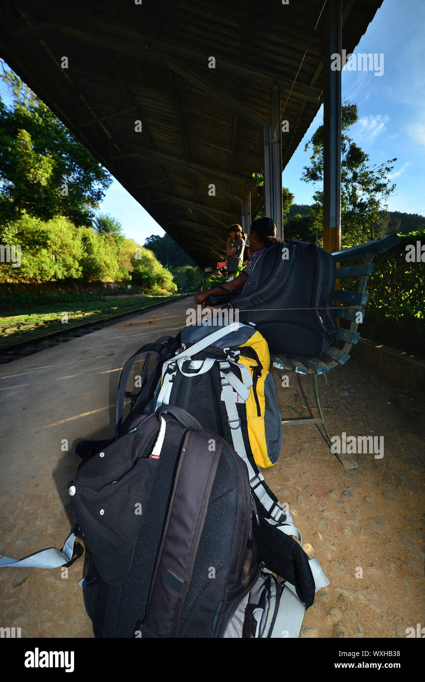 Tourist backpack on the floor while waiting for the train. Stock Photo