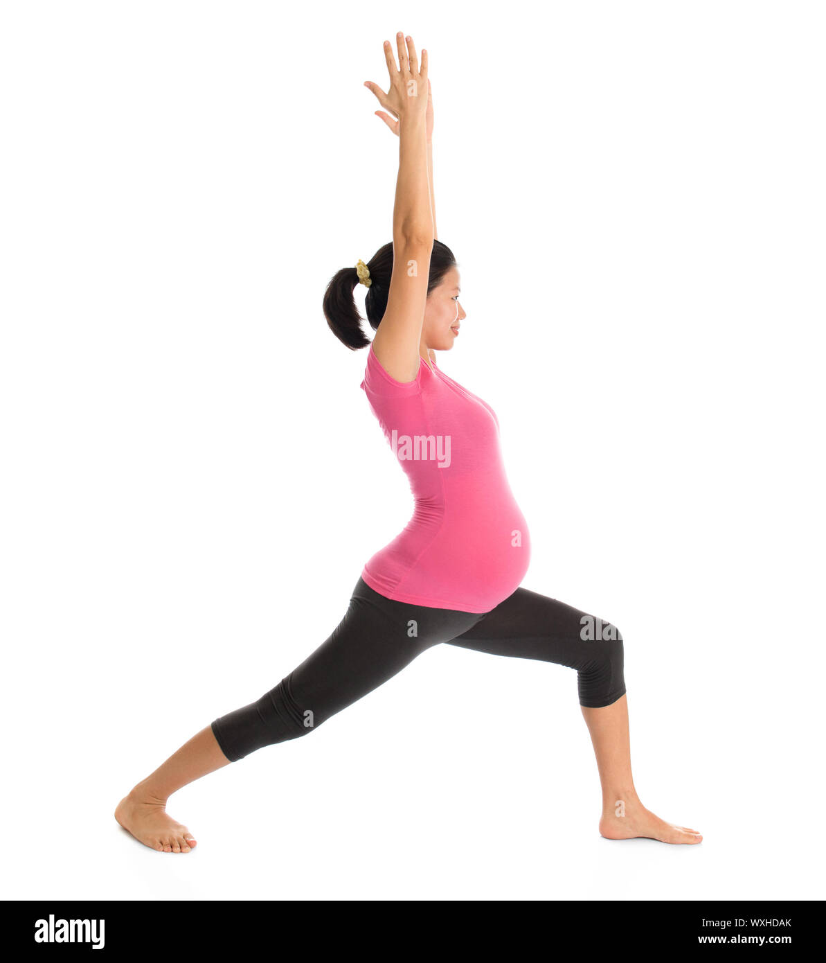 Prenatal yoga class. Full length healthy Asian pregnant woman doing