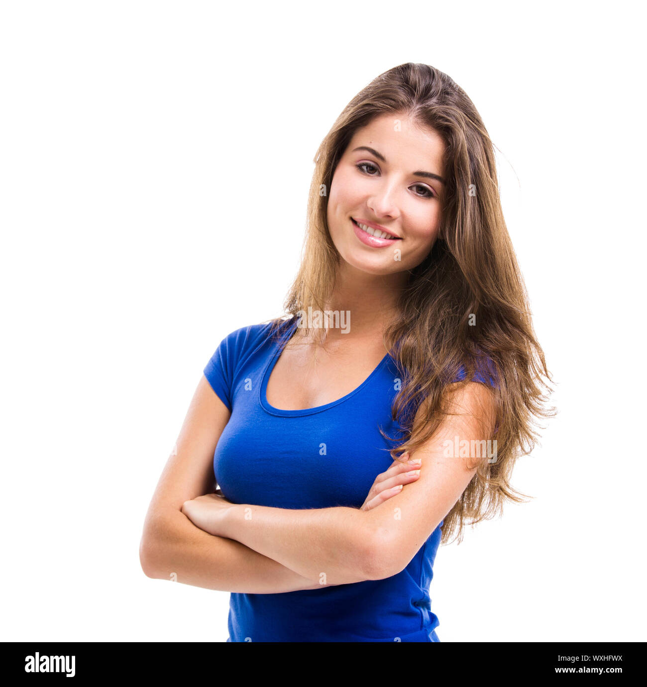 Beautiful young woman standing with arms crossed over a white