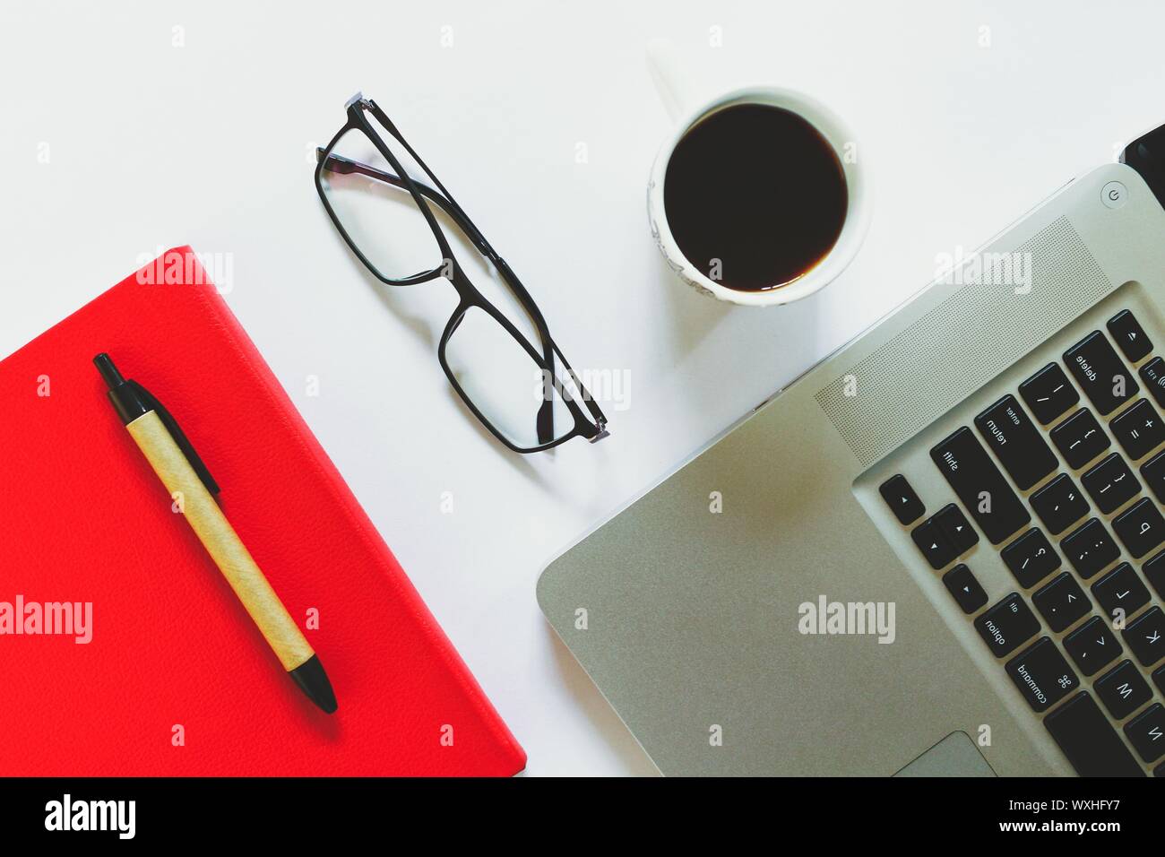 Office laptop notebook book pen Stock Photo - Alamy