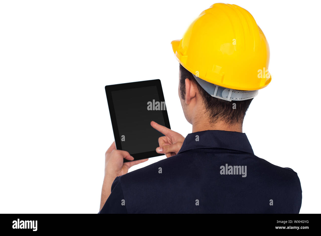 Young construction worker operating touch pad device Stock Photo