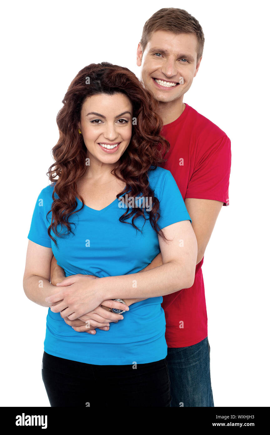 Handsome young man hugging his girl friend from back, holding her waist  Stock Photo - Alamy