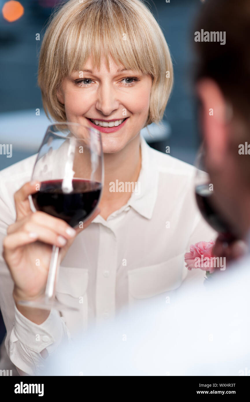 Couple cherishing memories while drinking red wine in restaurant. Stock Photo