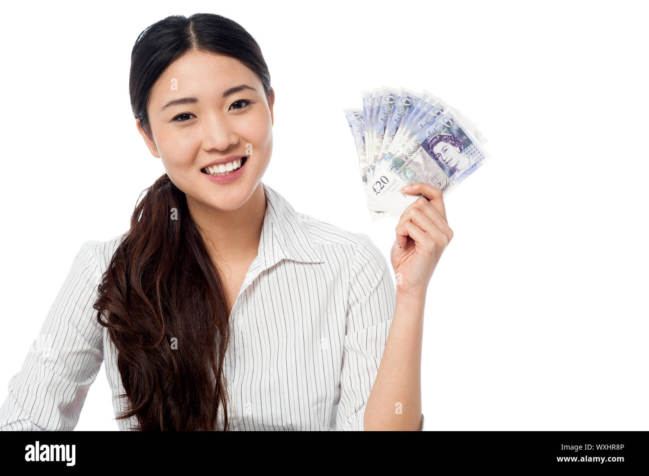 Woman showing british pound currency fan isolated over white background ...