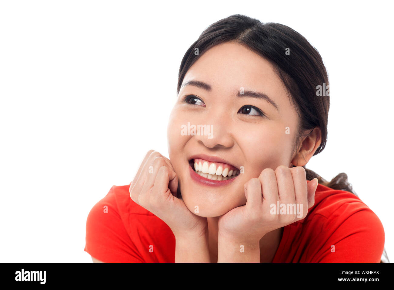 Young asian girl looking upwards and thinking of notorious idea Stock ...