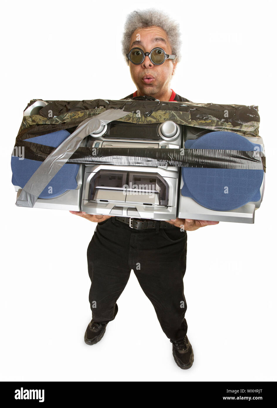 Man having difficulty carrying large 1980s portable radio Stock Photo